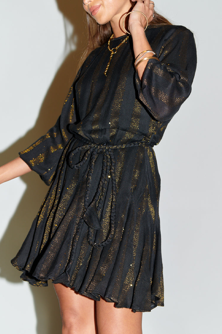 Model wearing Black And Gold Riri Dress