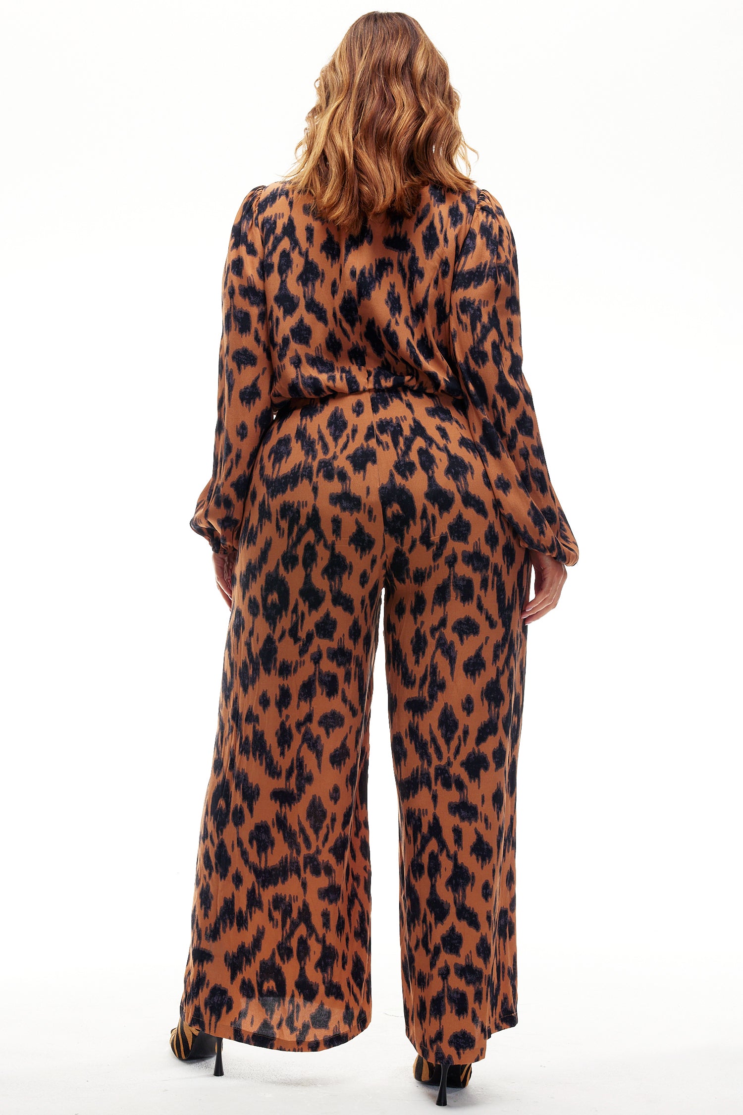 Model wearing Animal Jumpsuit standing facing away from the camera