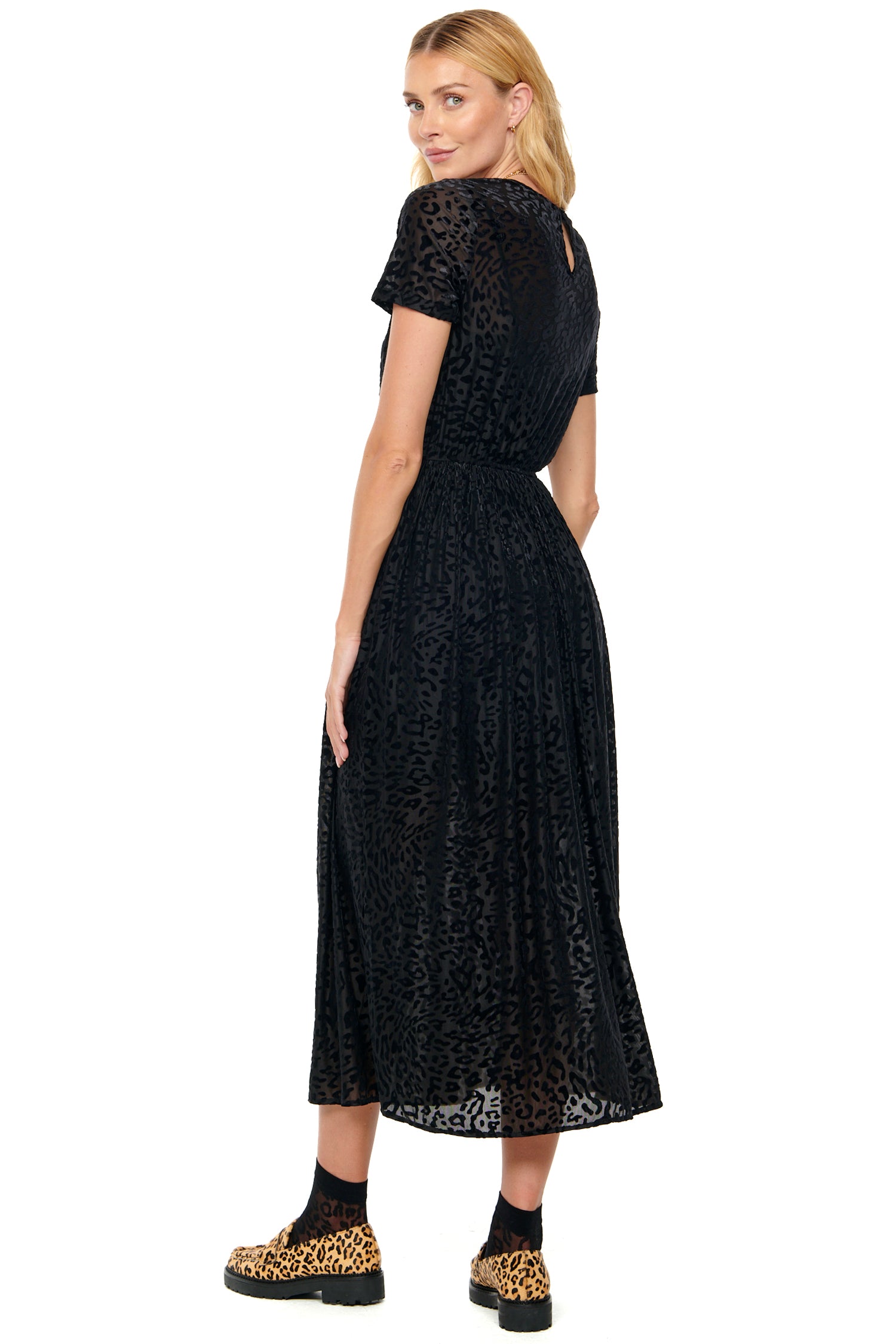 Model wearing Black Animal Devoree Dress standing facing away from the camera