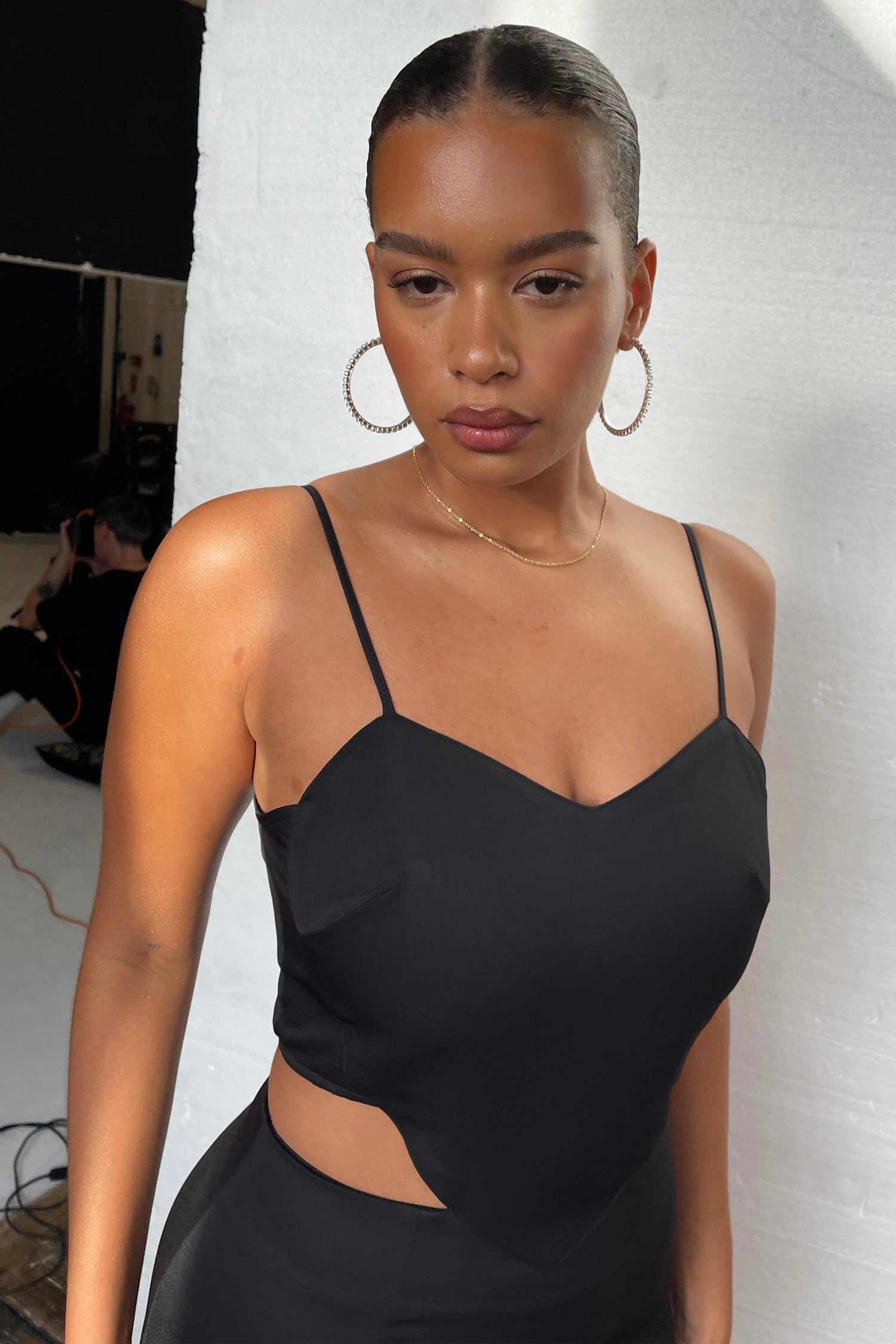 Model wearing Black Love Story Mini Dress standing facing the camera close up