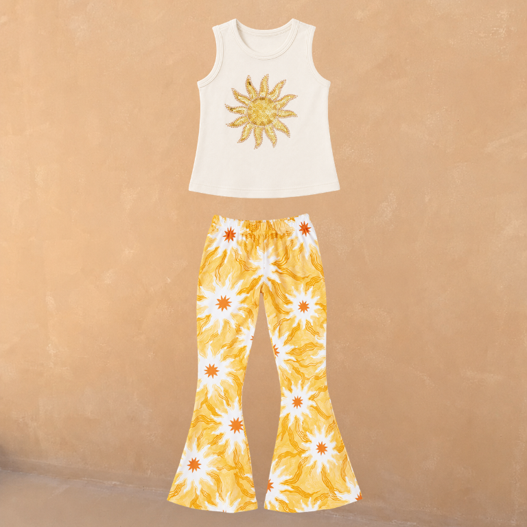 Cream cotton vest with a sequin sun and matching flared trousers in a yellow soleil print.