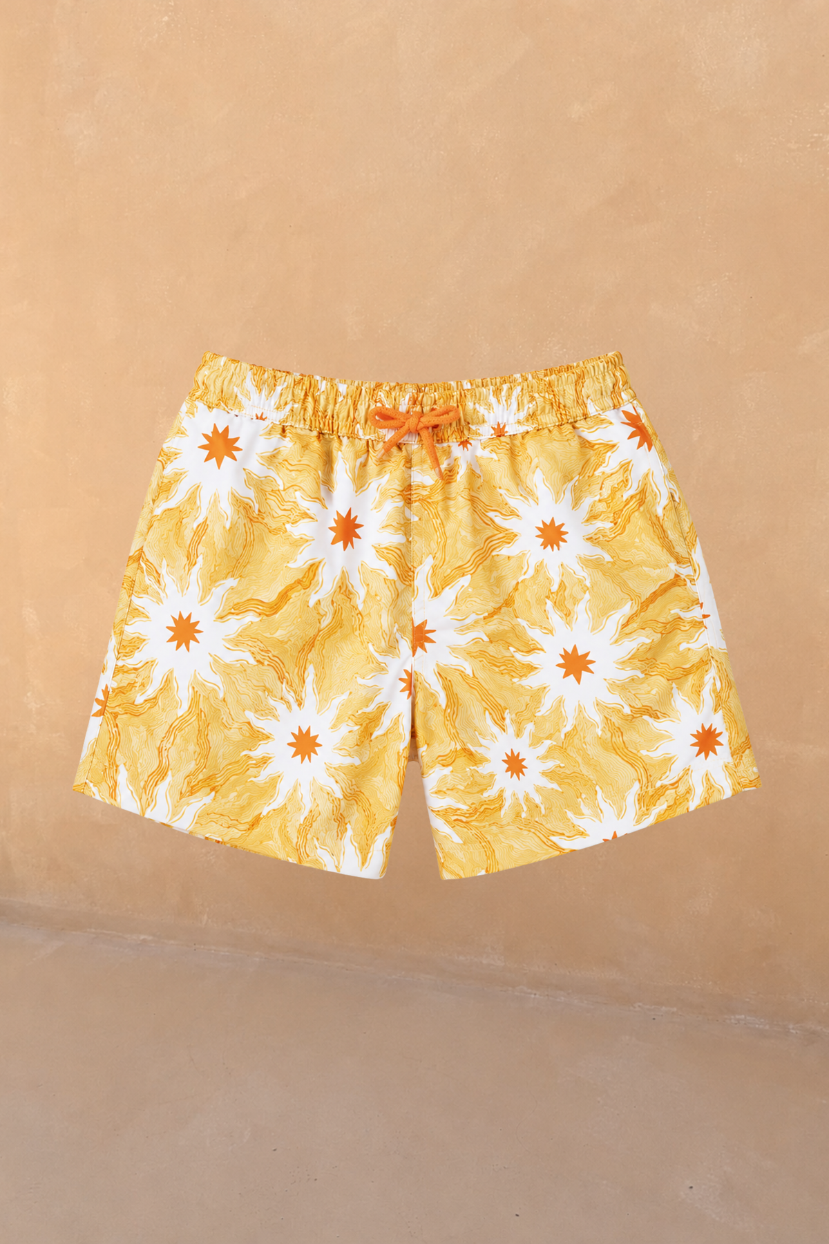 Boy's Yellow Sun Swim Shorts in recycled fabric featuring an orange sun print and elasticated waistband.