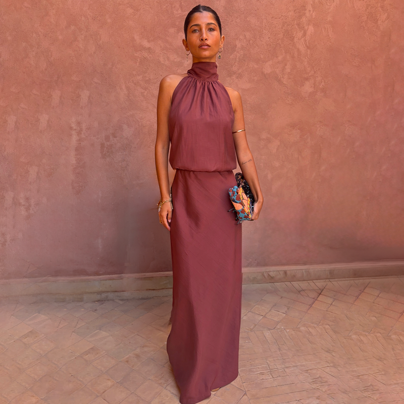 Chocolate Daphne Skirt and matching halter neck top worn as a co-ord against a textured pink wall.