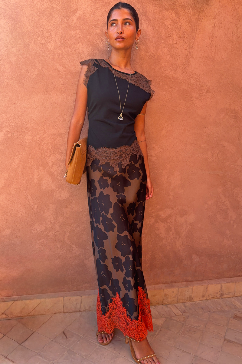 Black and Chocolate Lace Jersey Top with brown lace trim and Persi floral skirt, a London look against a terracotta wall.