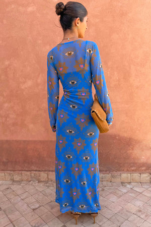 Blue Eye Mesh Maxi Dress with heart and eye motifs and long sleeves, shown from the back on a model.