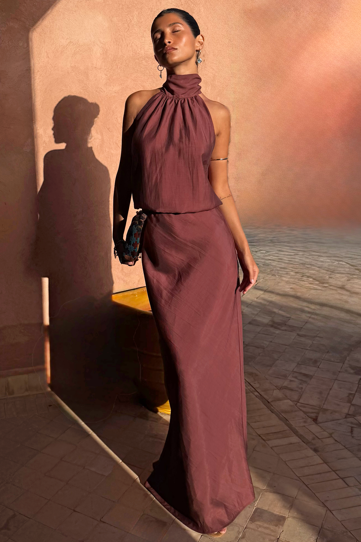 Chocolate Daphne Skirt and halter neck top co-ord with a high-waisted fit in a sunlit setting.