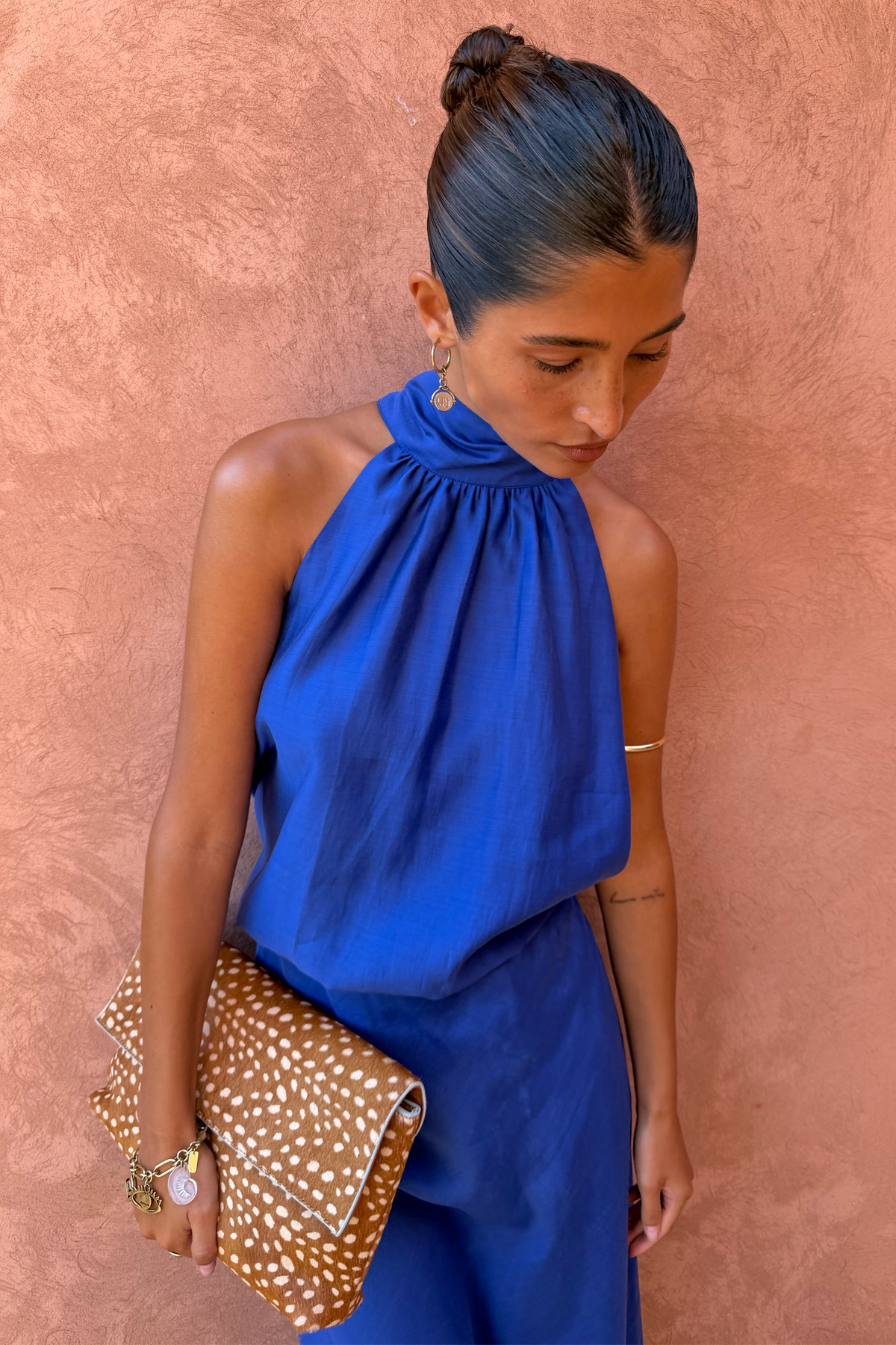 Cobalt Billie Top featuring a high halterneck and soft gathered neckline, styled with a leopard print clutch.