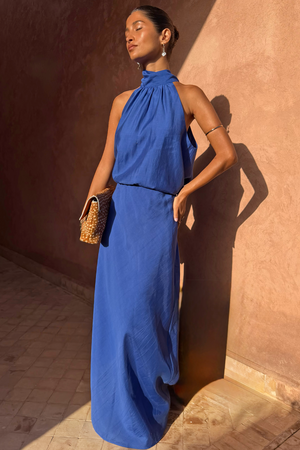 Cobalt Billie Top featuring a high halterneck and scarf detail, styled as a co-ord with a matching skirt.