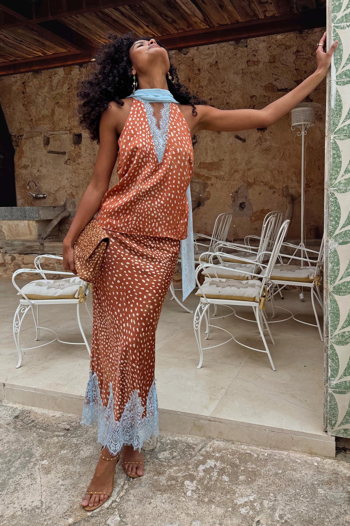 Fawn print Midi Maeva Skirt with light blue lace trim, styled as a matching co-ord on an outdoor terrace.
