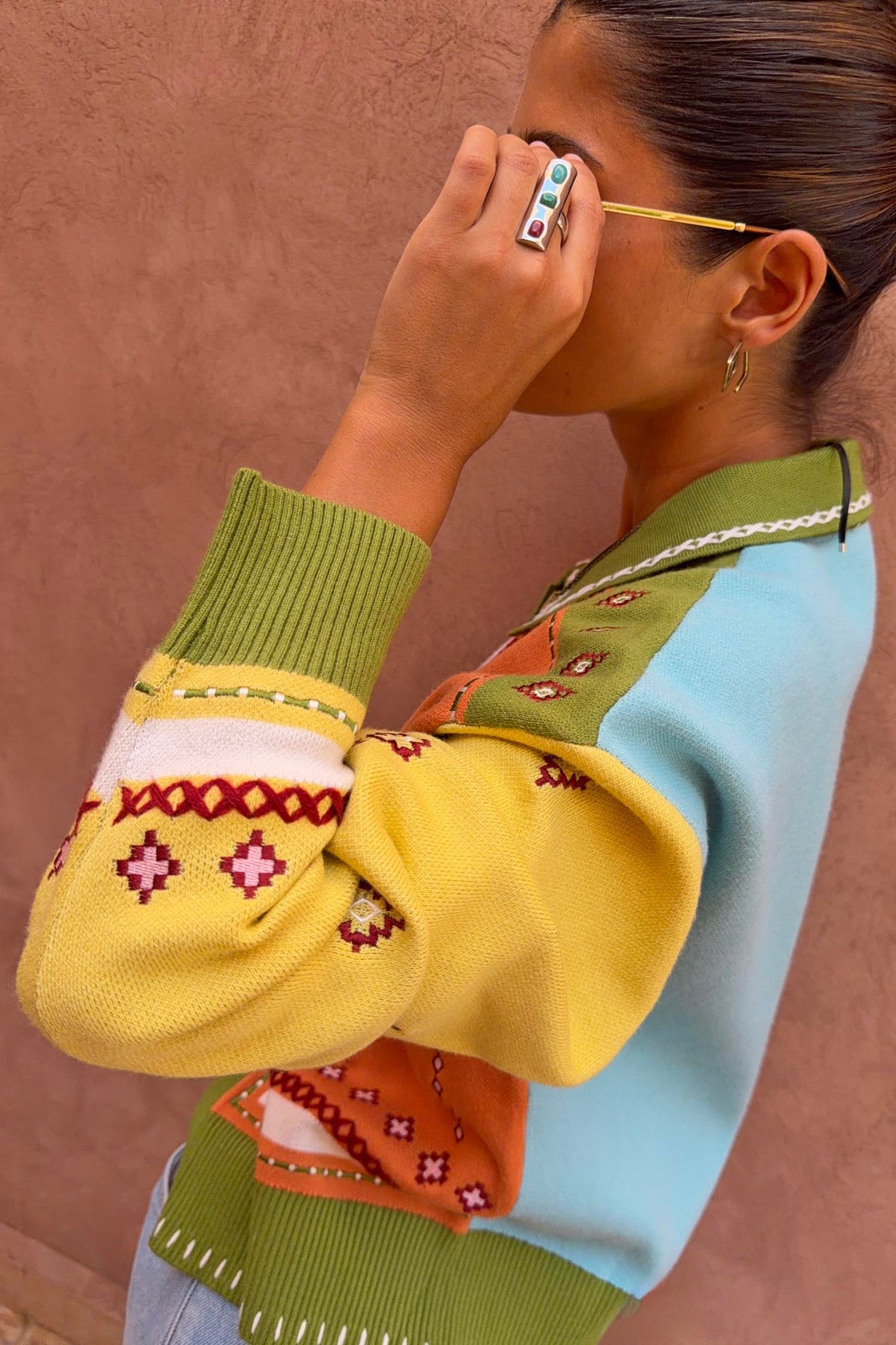 Green Geometric Palm Cardigan in a colourful jacquard knit with palm motifs and white blanket stitch detail.