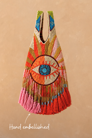 Dolce Vita Eye Bag featuring hand-embellished glass beads, a central eye motif, and pink and red tassels.
