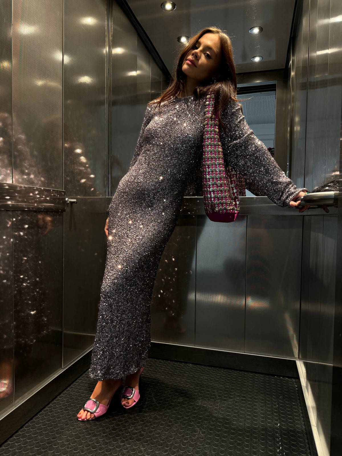 Gunmetal Sequin Soho Dress with a body-skimming fit and long sleeves, worn by a size 8, 5ft5” model in a lift.