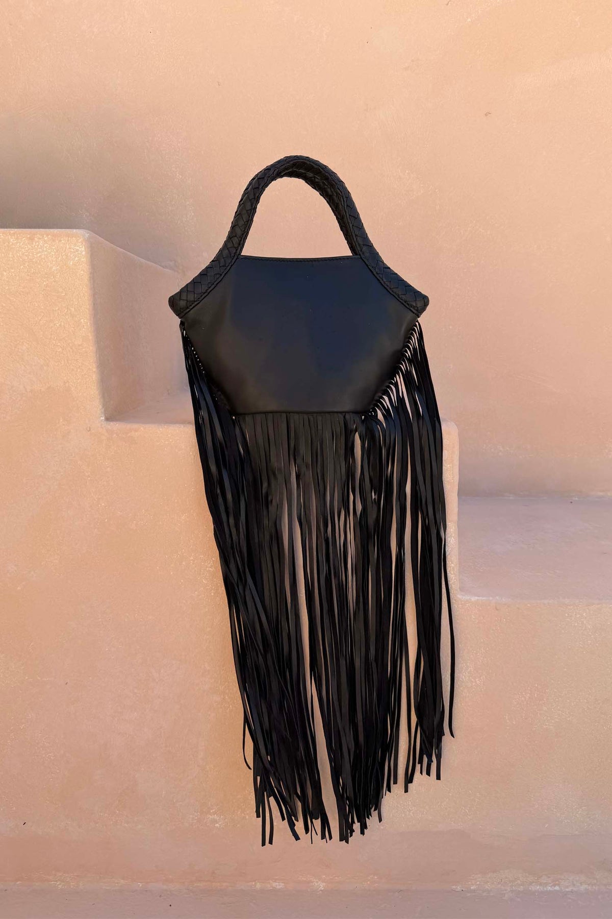 Black Leather Fringe Bag with a plaited handle and long fringe, a versatile statement staple.