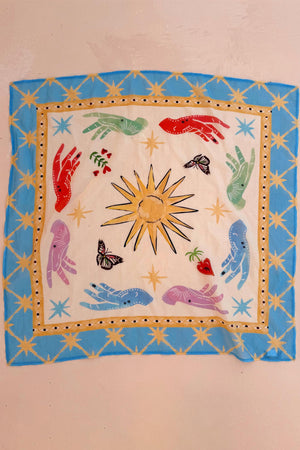 Celestial Bandana featuring hand-painted sun, mystical hands and eye motifs within a bold blue star border.