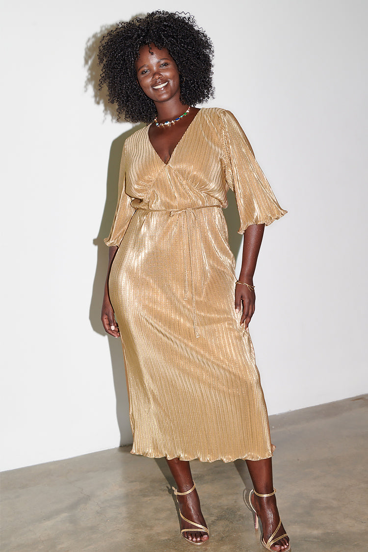 Model wearing gold plisse dress