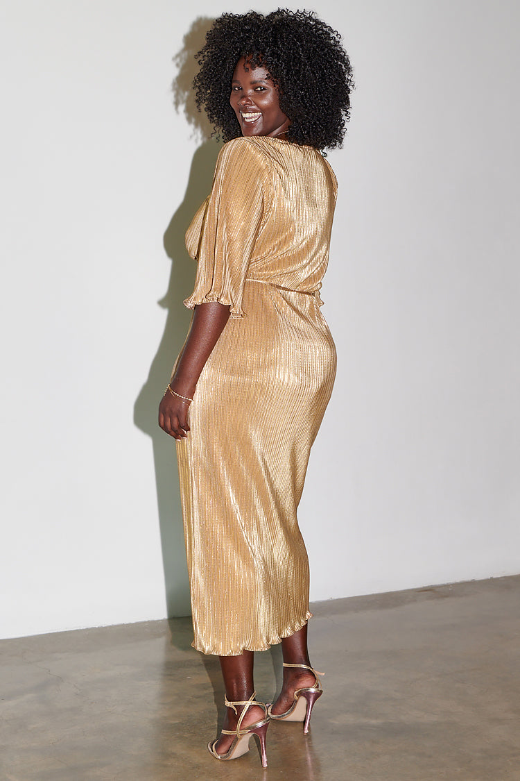 Model wearing gold plisse dress