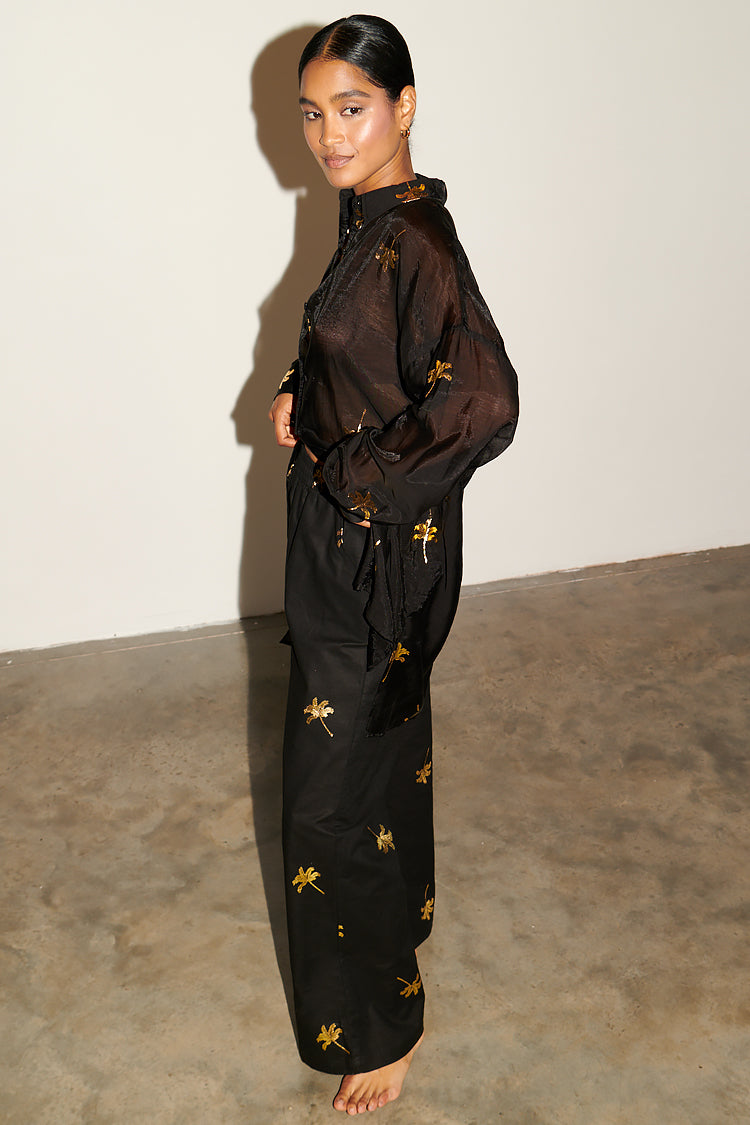 Model wearing Black with Gold Palm Fleck Trousers