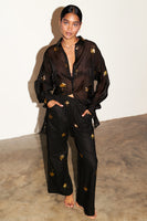 Thumbnail for Model wearing Black with Gold Palm Fleck Trousers