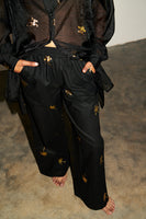 Thumbnail for Model wearing Black with Gold Palm Fleck Trousers