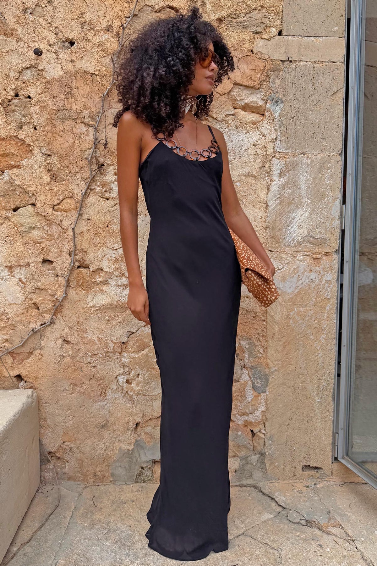 Black Sapna Petite maxi dress featuring a statement ring-detail neckline and a sleek fitted silhouette.