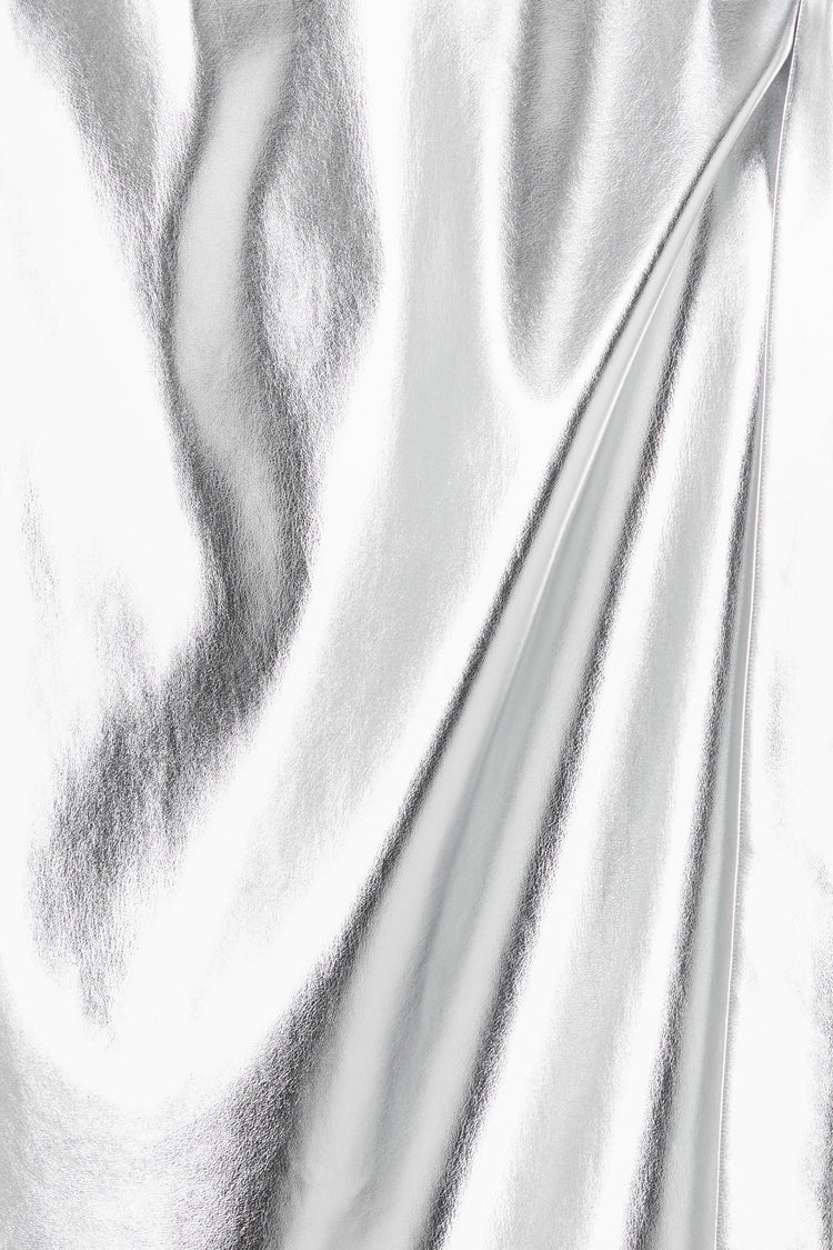 Close-up of metallic silver vegan leather fabric on the iconic Jaspre wrap skirt.