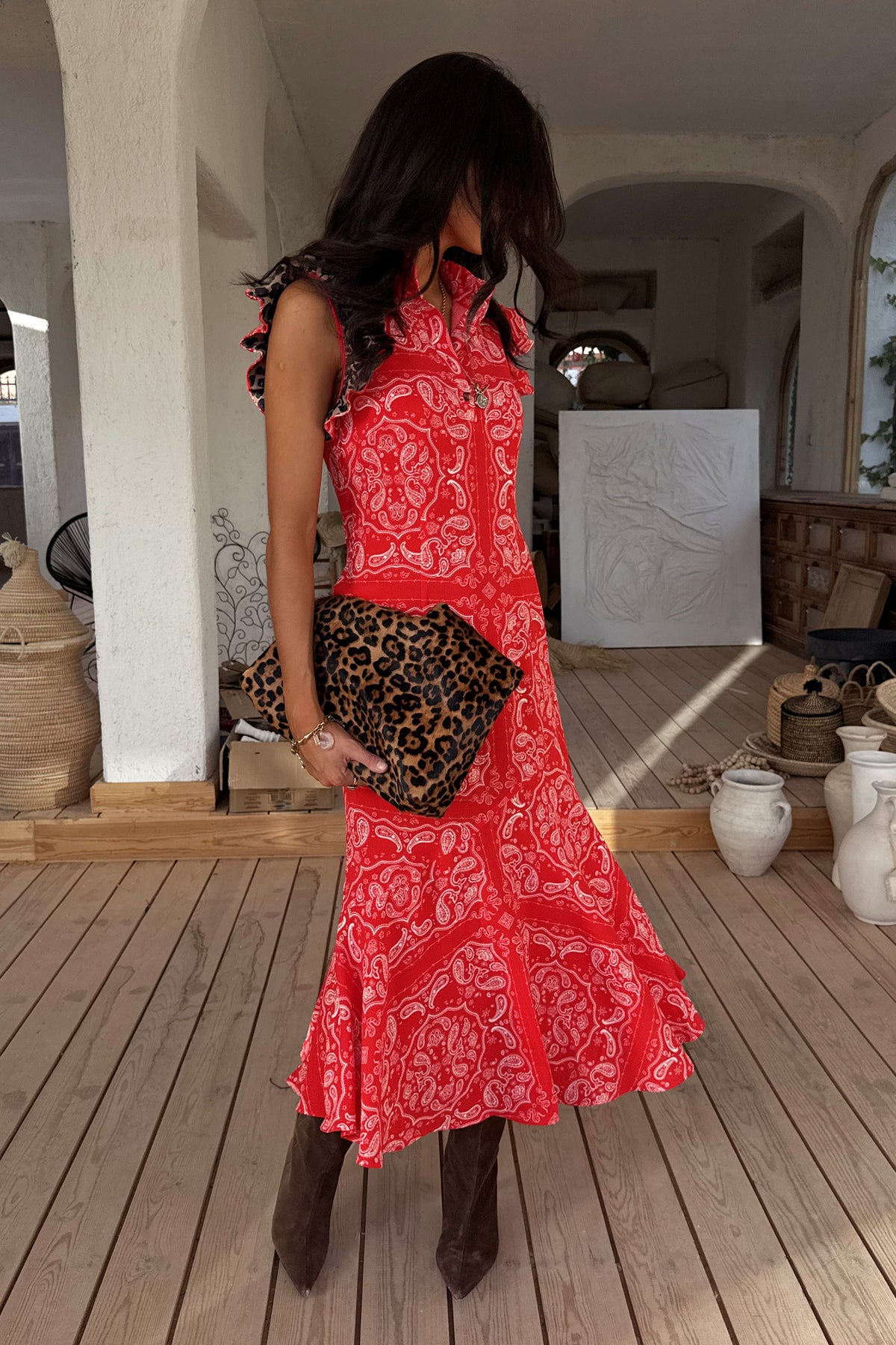 Red Bandana Remi Dress featuring leopard print sleeves and an asymmetrical frill hem, styled with a leopard clutch.