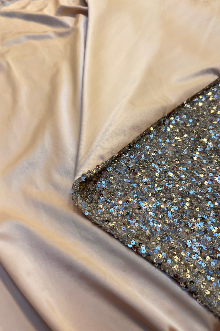 Silver Sequin Mini Jaspre Skirt showing the shimmering sequins and smooth satin lining.