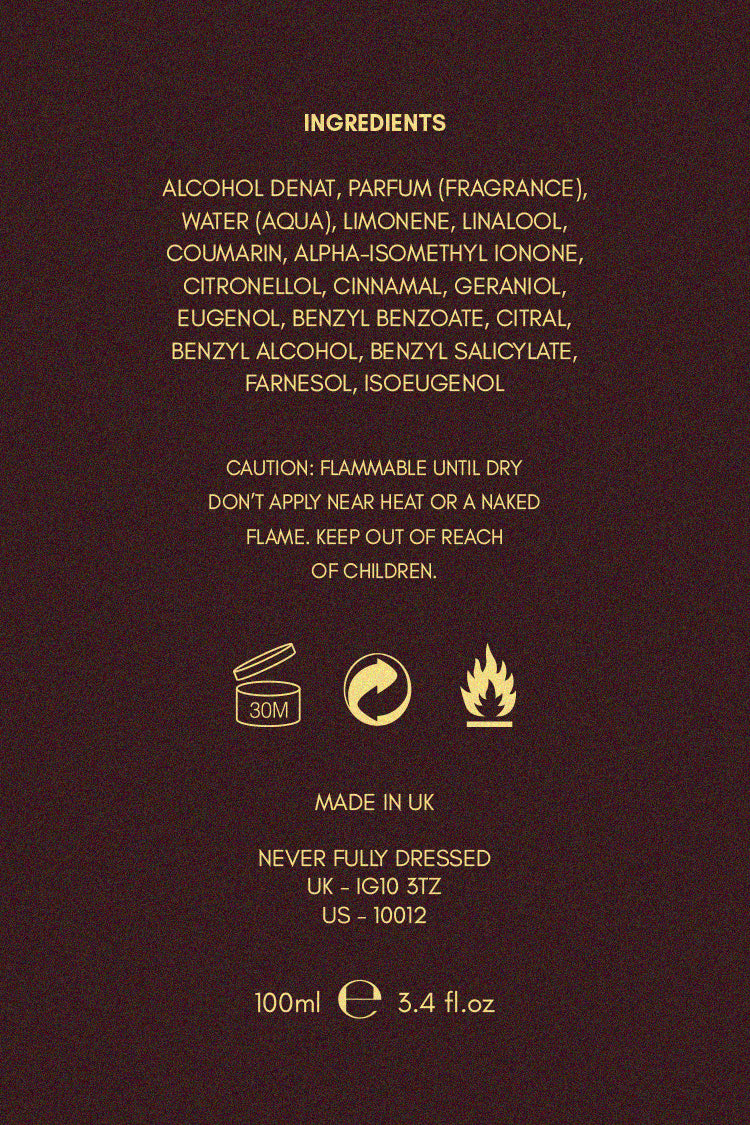 NFD Eau De Parfum 001 ingredient list and safety icons in gold text on a dark, textured background.