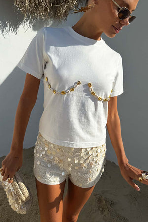 Cream Shells Hot Pants featuring pearlescent sea shell beads and glass beading, styled for a beach vacation.