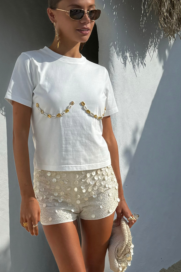 Cream Shells Hot Pants with pearlescent shell beads and glass beading, styled for a summer vacation look.