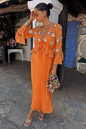 Apricot Embellished Ines Dress featuring mirror detailing and ruffled sleeves for a summer vacation look.