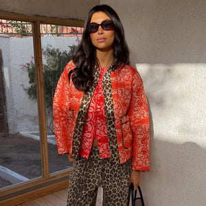 Red Bandana Reversible Jacket in quilted fabric with leopard trim, styled with leopard print trousers.