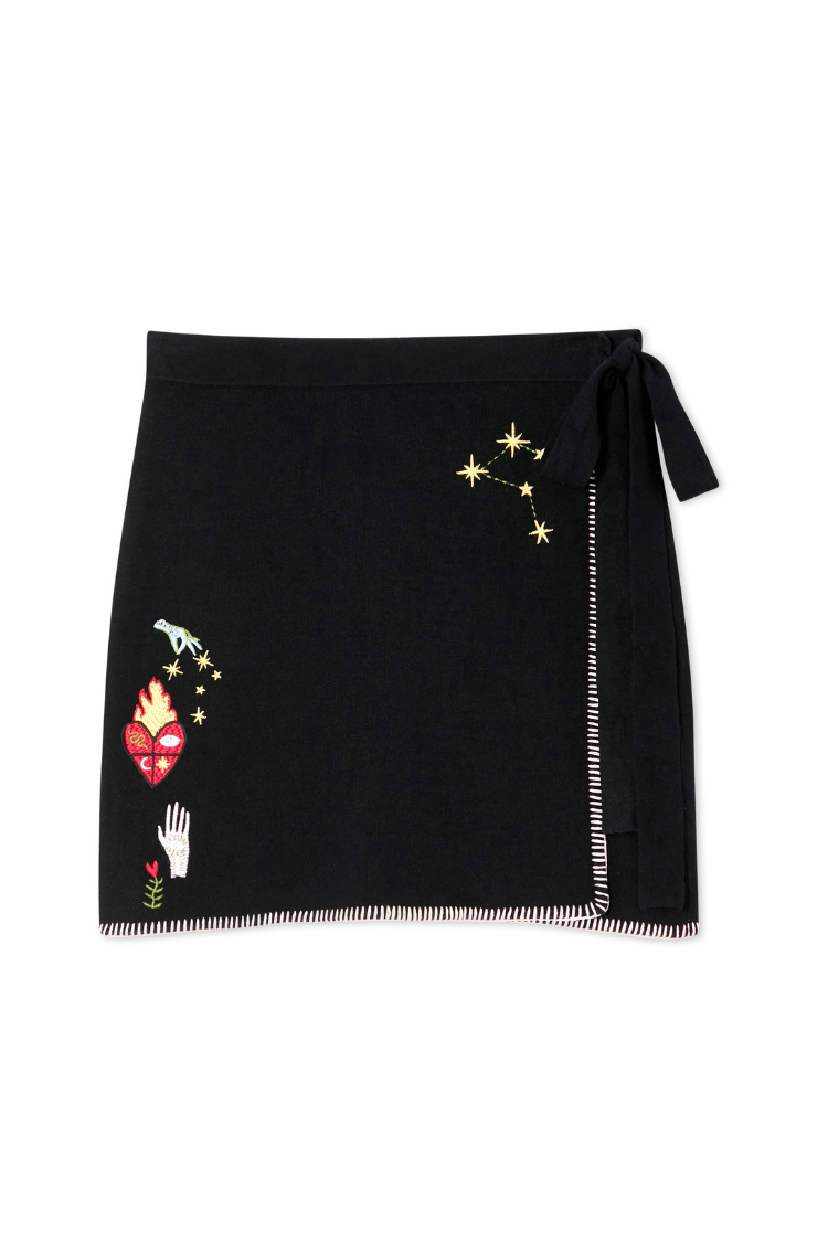Black Night Garden Mini Wrap Skirt in soft knit with celestial motifs, contrast pink blanket stitching and side wrap tie.