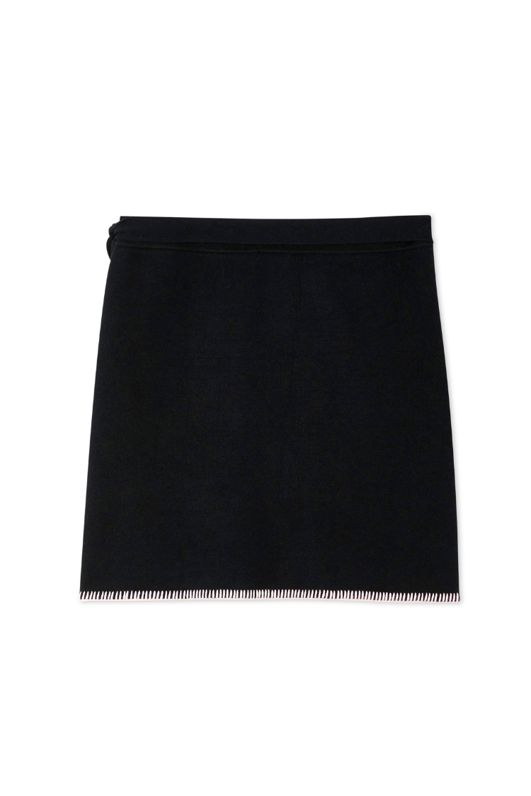 Black Night Garden Mini Wrap Skirt with a pink blanket stitch hem and side wrap tie in a soft-touch knit.