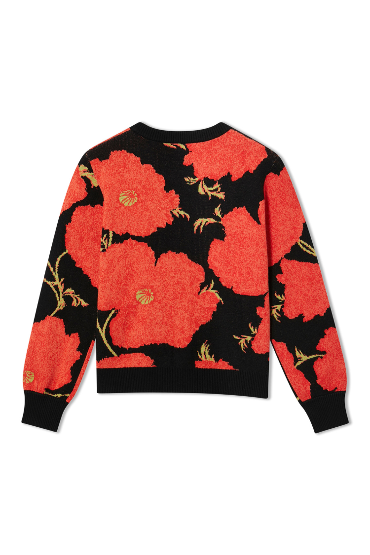 Black Poppy Cardigan featuring an iconic red floral print on a soft luxe knit with a ribbed hem and cuffs.