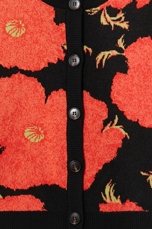 Black Poppy Cardigan detail featuring the iconic red poppy print on a black knit with dark button fastenings.