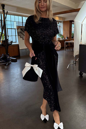 Black Sequin Bow Dress featuring a black velvet multi-wear tie and shimmering sequins, styled with bow heels.