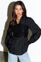 Thumbnail for Model wears Black Sequin Crop Top over black shirt
