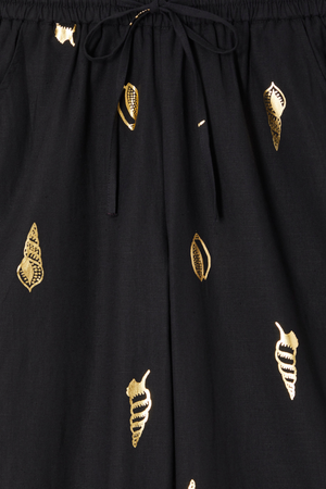 Black Shell Elissa Trousers detail showing the elasticated drawstring waist and metallic gold shell print.