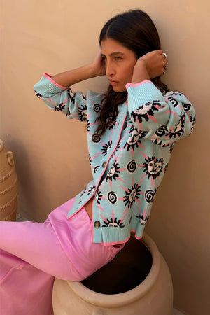 Blue Sun Hollie Cardigan in blue soft touch knit featuring pink sun prints and button-up fastening.