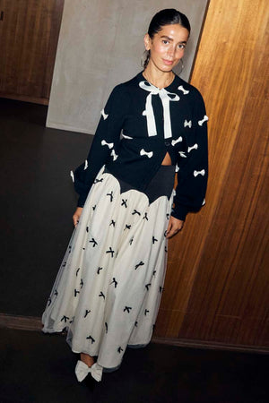 Black Bow Sophie Cardigan featuring white contrast 3D bows and a tie-neck fastening in a soft heavy knit.