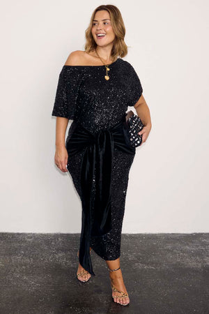 Black Sequin Bow Midi Dress with a velvet tie waist and off-the-shoulder neckline for party season styling.