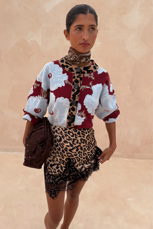 Burgundy & Blue Poppy Cardigan with iconic poppy print and leopard trim, styled with a leopard lace skirt.