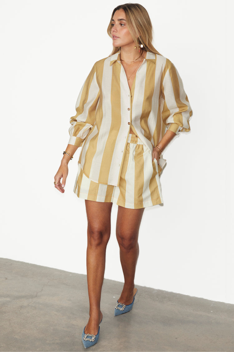 caption_Model wears Camel Stripe Elissa Shorts in UK size 10/ US 6