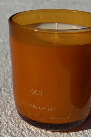 NFD Eau De Parfum Candle 002 in a mandarin-toned glass jar with signature branding.