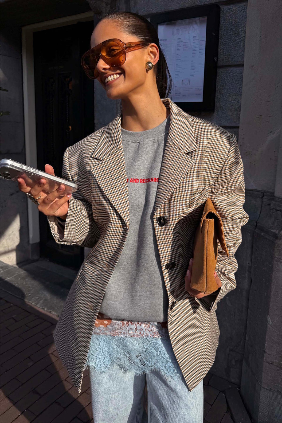 Modella con blazer a quadri vichy giallo su felpa grigia per un look London street style.