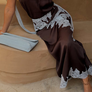 Chocolate Lily Skirt in brown satin with light blue lace trim, styled with a matching top and light blue clutch.