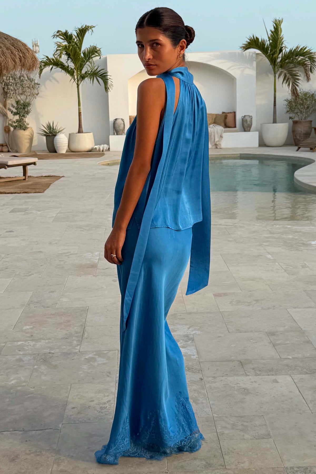 Cobalt Maeva Midi Skirt with a lace hem and matching top, styled as a co-ord in a poolside vacation setting.