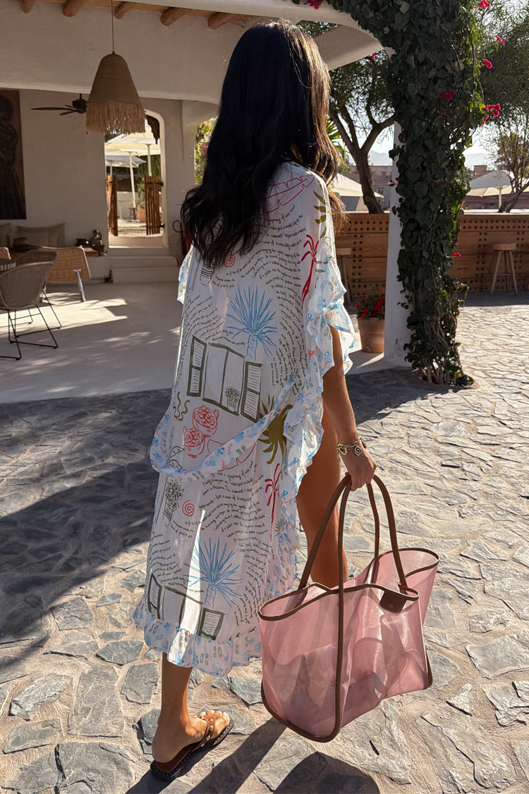 Kimono Cream Palma con stampa illustrata colorata e bordi a volant, indossato con borsa rosa.