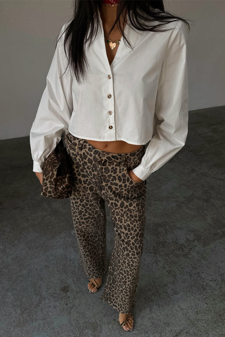 White Cropped Cotton Miley Shirt with blouson sleeves and tortoise buttons, paired with leopard print trousers.